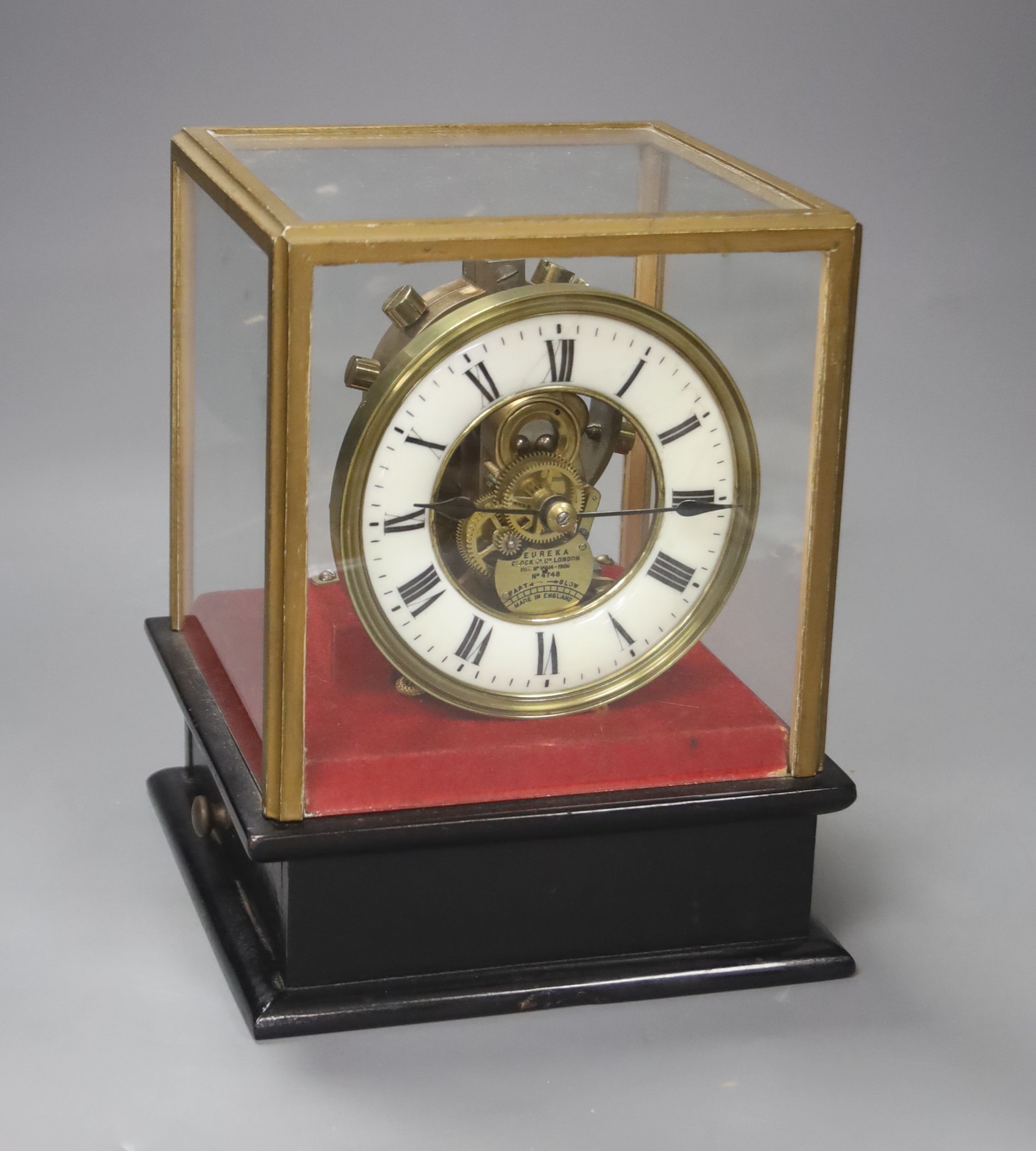 A Eureka Clock Co. Ltd electric clock in four glass case